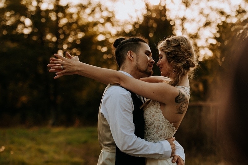 Wedding Photography, bride with her arms around grooms neck, looking into each other's eyes