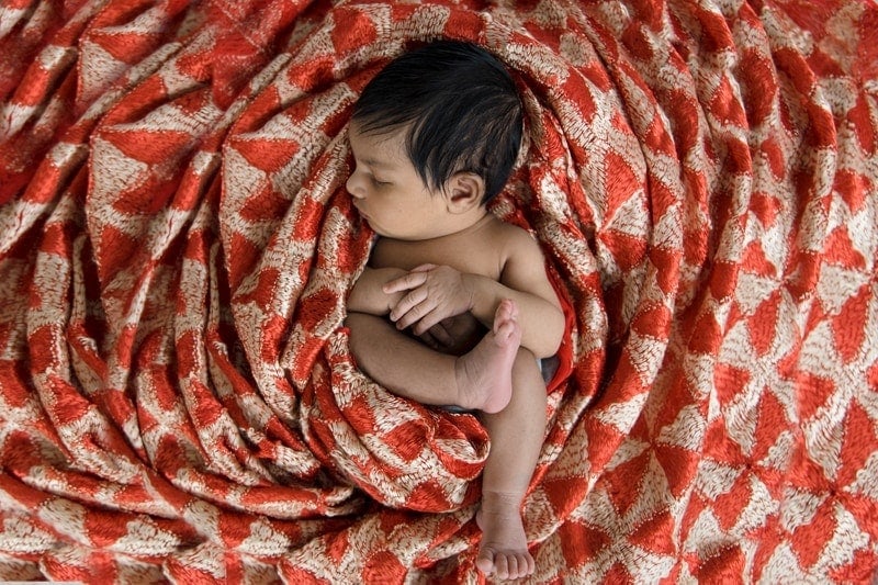Baby Photography, baby asleep in red and tan quilted blanket