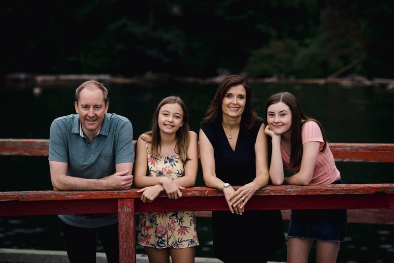 Family Photography, family of 4 leaning on an old wooden rail
