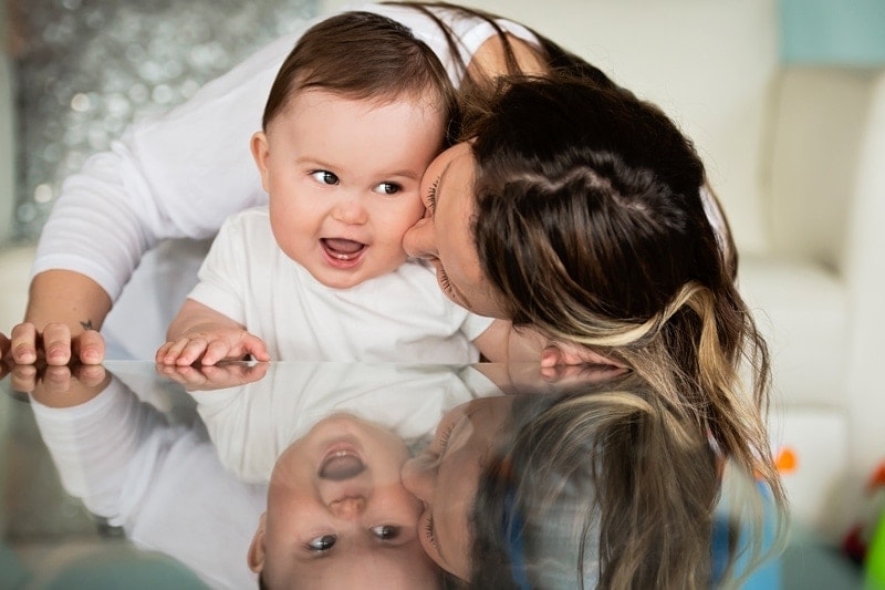 Family Photography, mother giving baby boy a kiss on cheek