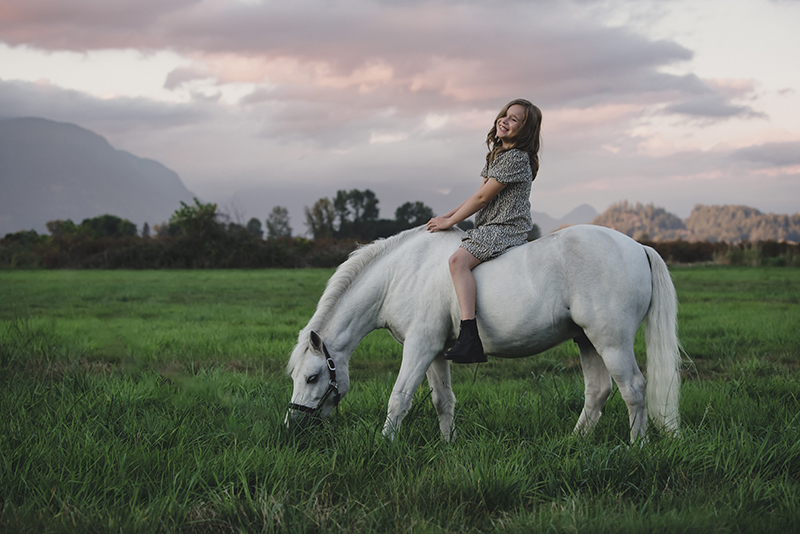 kid and horse, pony in a field, grass, sunset